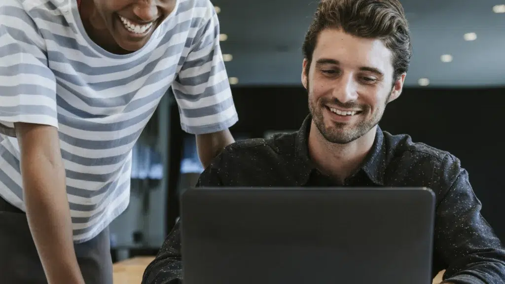 Colleagues Discussing Their Work Laptop