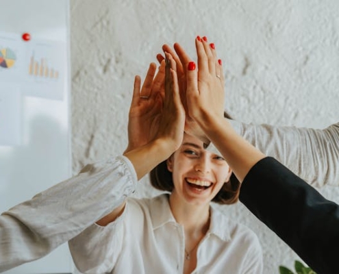 Happy woman high five career development goals